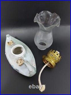 A porcelain and glass lantern with a kerosene wick