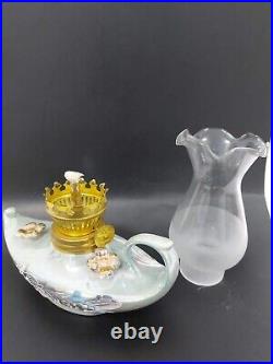 A porcelain and glass lantern with a kerosene wick